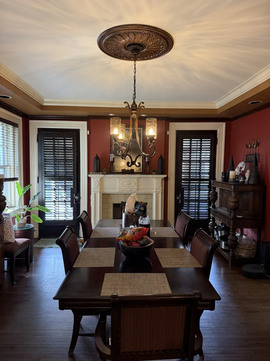 Dark stained plantation shutters on two French doors in a traditional dining room in a Columbus, Ohio home